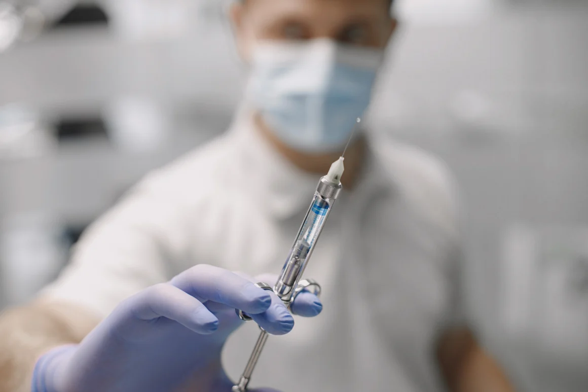 close-up-man-dentists-hand-glove-with-syringe-full-anesthesia-pain-relief-injection-prevention-health-care-concept Sedation and Anesthesia Unit